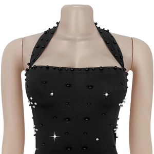 Close-up of black halter-neck dress with intricate beadwork and sparkling rhinestones