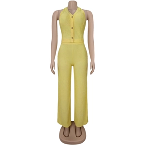 Detail of lemon yellow pleated fabric set with gold buttons and halter neck texture