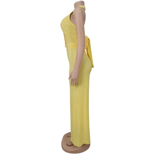 Detail of yellow halter top and wide leg pants with pleated texture and back bow tie