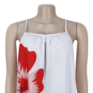 Close-up of floral print details and pleated neckline on a white strap dress