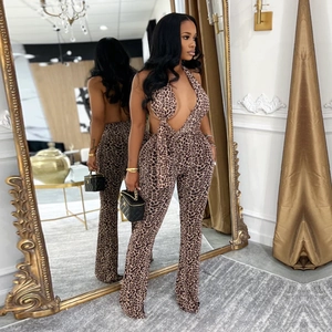 Detailed mirror view of leopard print halter jumpsuit featuring deep V-neck and open back design