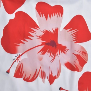 Close-up of red hibiscus floral print on white textile fabric for a summer dress