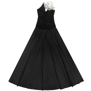 Close-up of elegant black one-shoulder dress with a large white 3D floral decoration