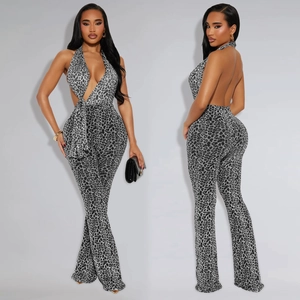 Detail view of leopard print jumpsuit featuring halter neck design and flared pant legs