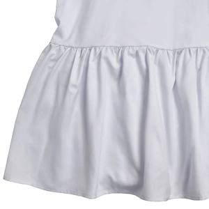 Detailed view of the white ruffled hemline and high-quality fabric stitching of the dress