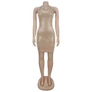 Close-up of beige halter dress with shimmering rhinestones for party wear