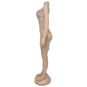 Detail of light gold mini dress featuring shimmering silver sequins and bodycon fit