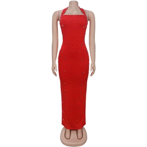 Detail of red halter dress featuring intricate bead embroidery and slim-fit texture