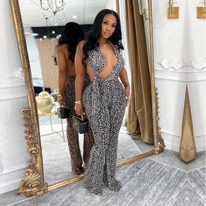 Deep V-neck backless leopard print jumpsuit with halter neck and flared leg fit