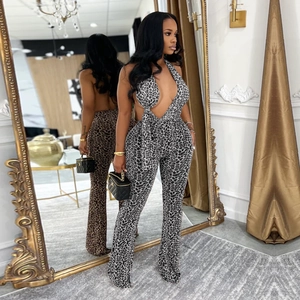 Detail view of leopard print halter jumpsuit showing the deep V-neck and backless design