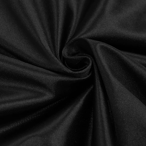 Macro detail of high-quality black pleated fabric showing elastic texture and drape