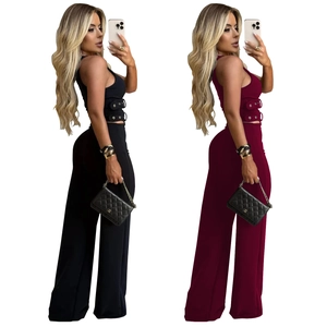 Detailed side view of V-neck top with metal buckles and matching wide-leg trousers