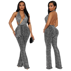 Detail view of leopard print halter jumpsuit featuring deep V-neck and open back design
