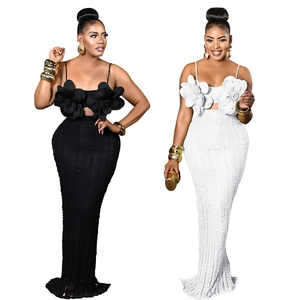 Women's two-piece set with floral crop top and long skirt in black and white colors