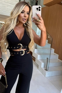 Detailed view of the V-neck crop top and high-waist pants with golden eyelet belts