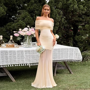 Detail showing elegant cream off-shoulder dress with ruched mesh and fishtail hem