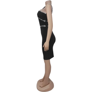 Detailed view of elegant black bodycon dress with diagonal rhinestone trim on the side