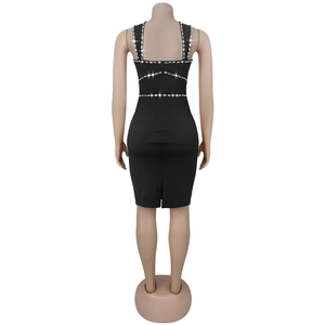 Detail of elegant black bodycon dress featuring rhinestone straps and back slit design