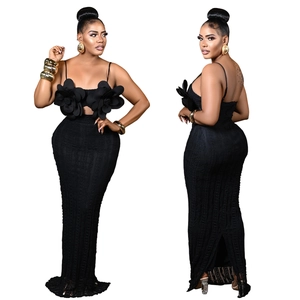 Detail of black two-piece set featuring 3D floral appliques and a high-waisted textured skirt
