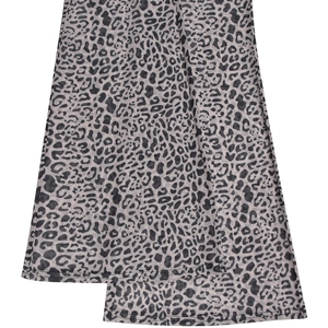 Detailed macro view of leopard print sheer mesh fabric on wide-leg jumpsuit hem