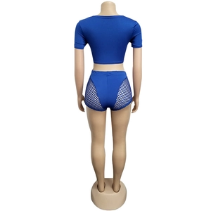 Back view of royal blue two-piece crop top and high-waisted shorts with mesh panels