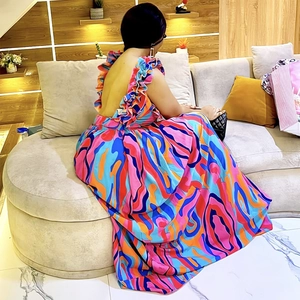 Detail of bohemian floral print dress showing open back with elegant ruffle shoulder straps