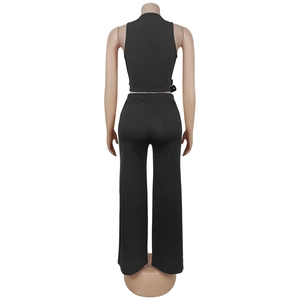 Rear view of black two-piece set featuring sleeveless crop top and high waist wide leg pants