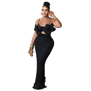 Detail of elegant black bodycon lace maxi dress with large 3D floral accent on bodice