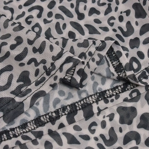 Detail shot of sheer mesh fabric with leopard print and high-quality overlock stitching