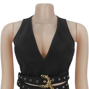 Close-up of black V-neck top featuring a wide belt with gold buckle and silver eyelets