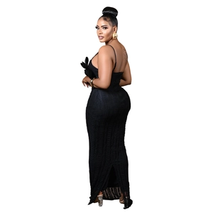 Close-up of black bodycon maxi dress with side 3D floral accent and back slit