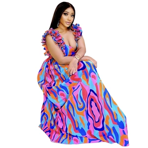 Close-up of ruffled shoulder straps and vibrant wave print on the elegant maxi dress