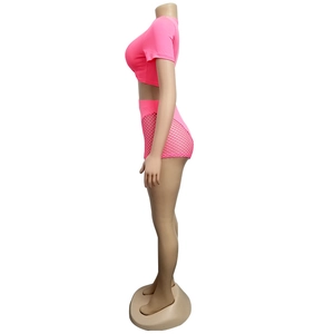 Side view of a neon pink crop top and high waisted fishnet shorts on a mannequin