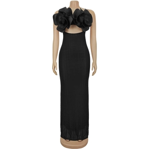 Detail of elegant black slim-fit dress featuring oversized 3D fabric flowers on the bust