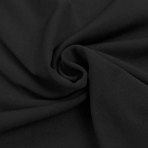 Close-up of elegant black fabric with fine grain texture and soft draped folds