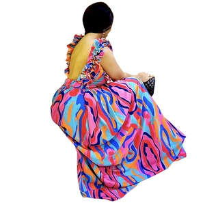 Detail view of colorful ruffled shoulder straps and open back on a floral maxi dress