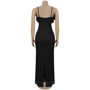 Detail view of black bodycon dress with thin straps, hidden back zipper and a back slit hem