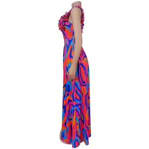 Close-up of ruffled shoulder straps and abstract geometric floral print on long dress