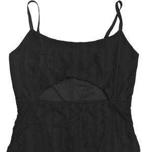 Detail of a black strapless dress with vertical texture and front cut-out design