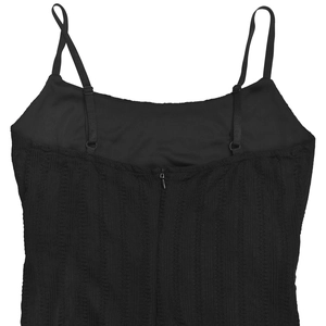 Detailed macro view of black lace textured fabric with adjustable thin straps and back zipper