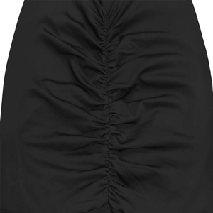 Close-up of ruched detail and elastic black fabric on an off-shoulder dress