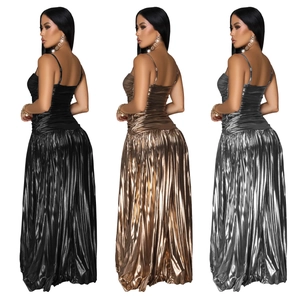 Detail view of women's metallic pleated cami maxi dresses in black, gold, and silver