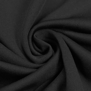 Détail du tissu tricoté noir de qualité montrant la texture fine et l'élasticité