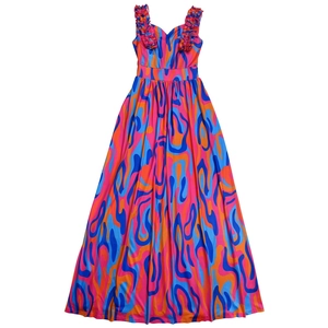 Close-up of ruffled shoulder straps and abstract wave print on maxi dress