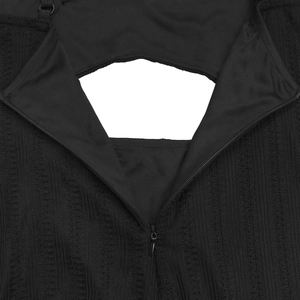 Close-up of invisible zipper and vertical ribbed texture on black backless dress