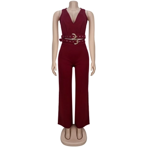 Detail view of burgundy V-neck jumpsuit with S-shaped gold buckle and belt