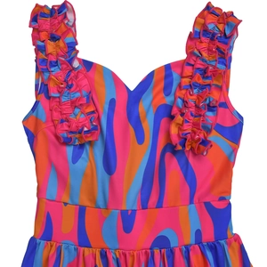 Detail showing ruffle shoulder straps and vibrant swirl print on the elegant dress