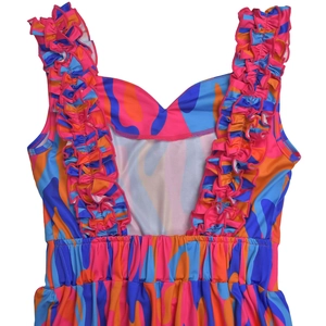 Detail of elegant ruffled shoulder straps and vibrant abstract floral print dress