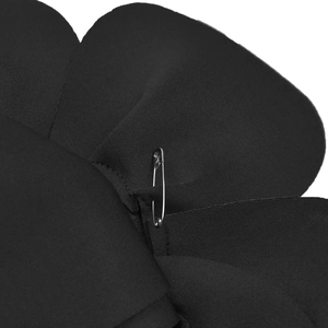 Detail of black ribbed fabric flower accessory with silver metal safety pin fastener