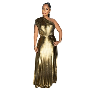 Detailed close-up of metallic pleated fabric on an elegant one-shoulder golden evening gown